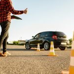 Instructor helps student to drives between cones